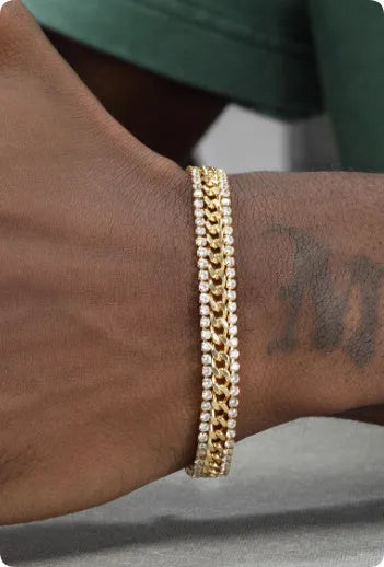Gold tennis bracelet with artificial gemstone inlay on wrist, showing hip hop style unisex design