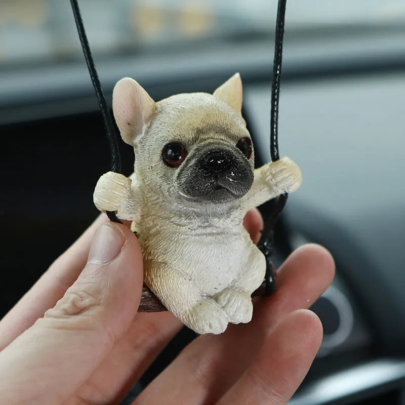 Cartoon-style resin bulldog car pendant hanging from a rearview mirror.