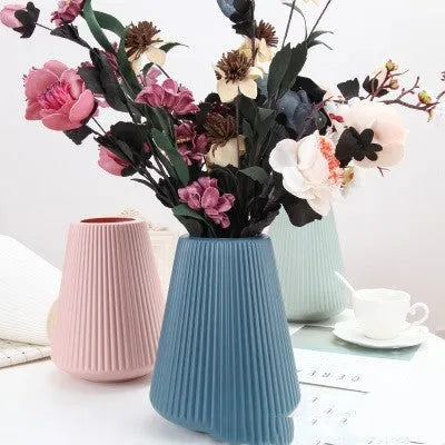 Blue, green, pink, and white melamine plastic decorative vase measuring 16cm by 20cm on a desktop.