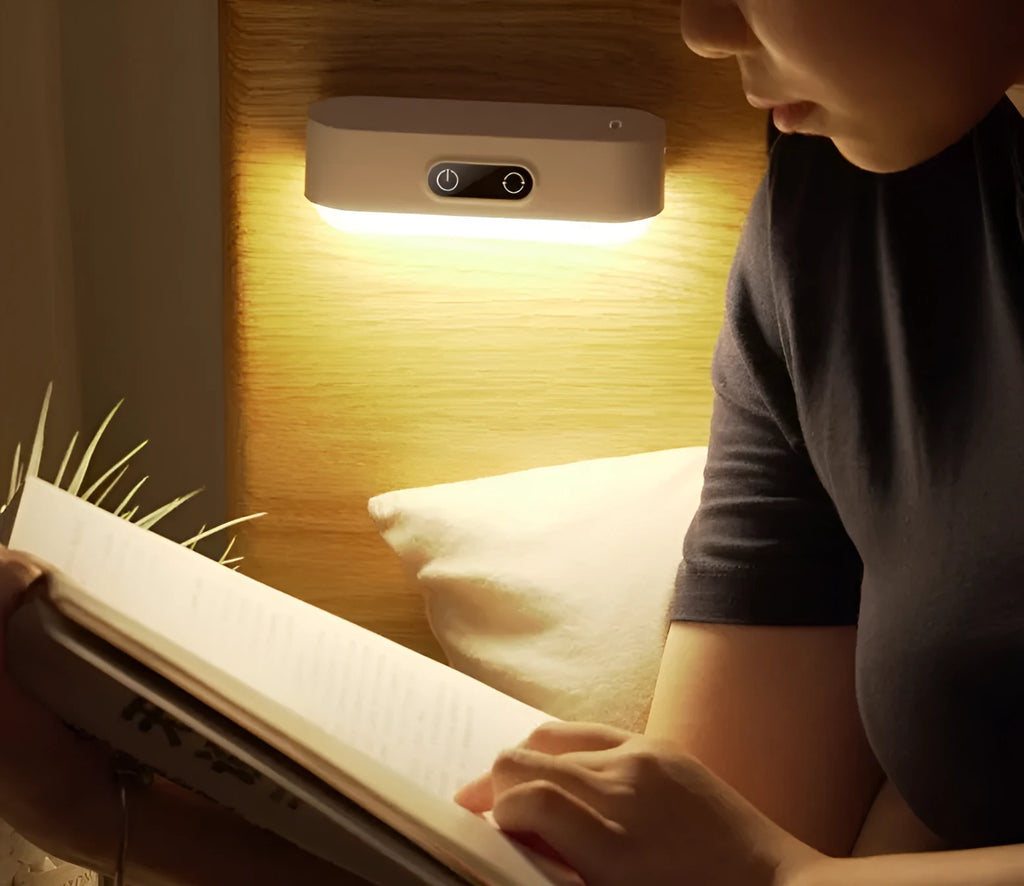 White magnetic USB rechargeable LED night light with touch controls and a curved light surface.