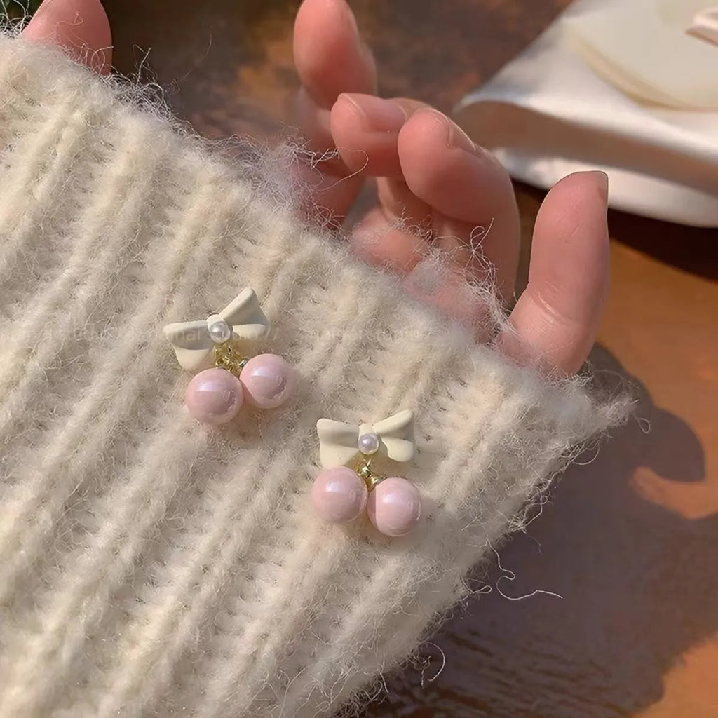 Pink alloy women's earrings with heart, pearl, and bow design, electroplated finish, sold as one pair