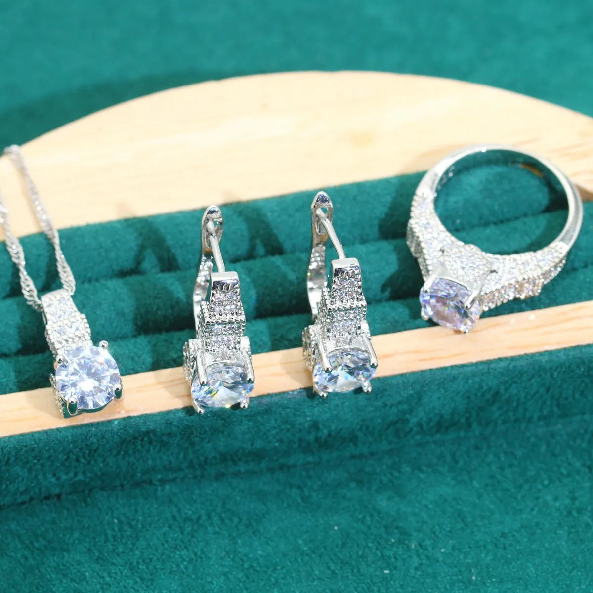 Four-piece bridal jewellery set showing zircon necklace, bracelet, earrings, and ring in coordinating design