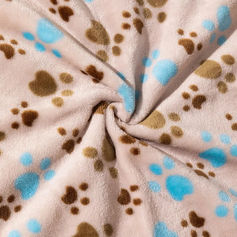 Blue cartoon dog pattern double-sided flannel pet blanket shown on a dog bed.