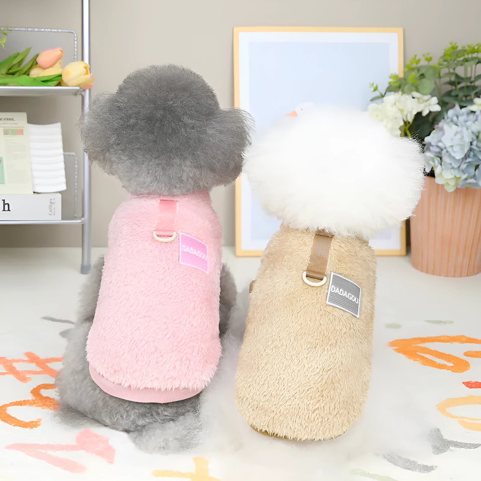 A blue coral fleece jacket for pets with five multi-coloured pull rings for adjustment on the front.