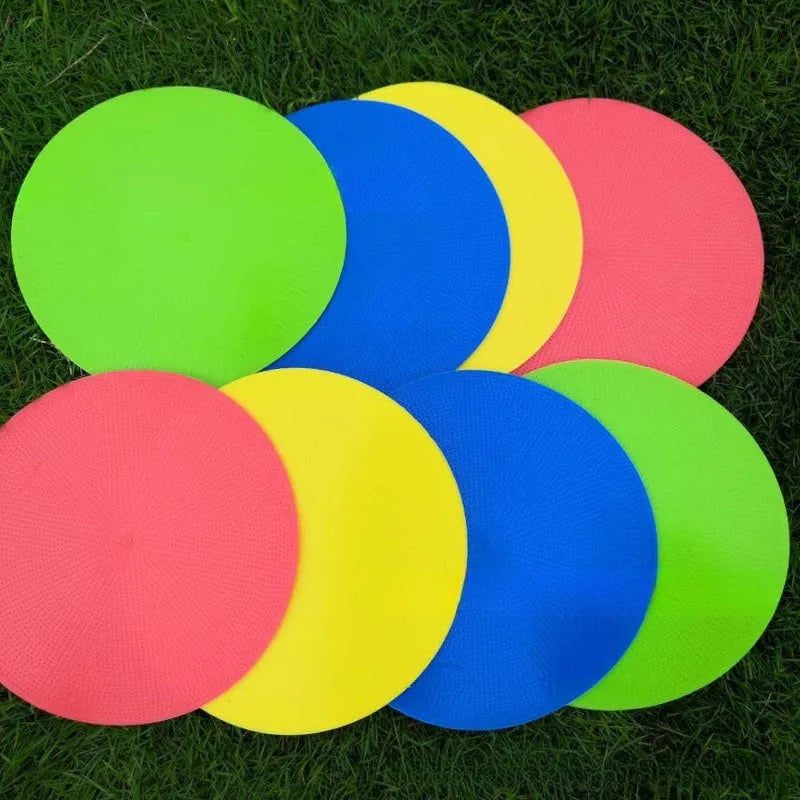 Yellow football training target disc with 23cm diameter on grass pitch