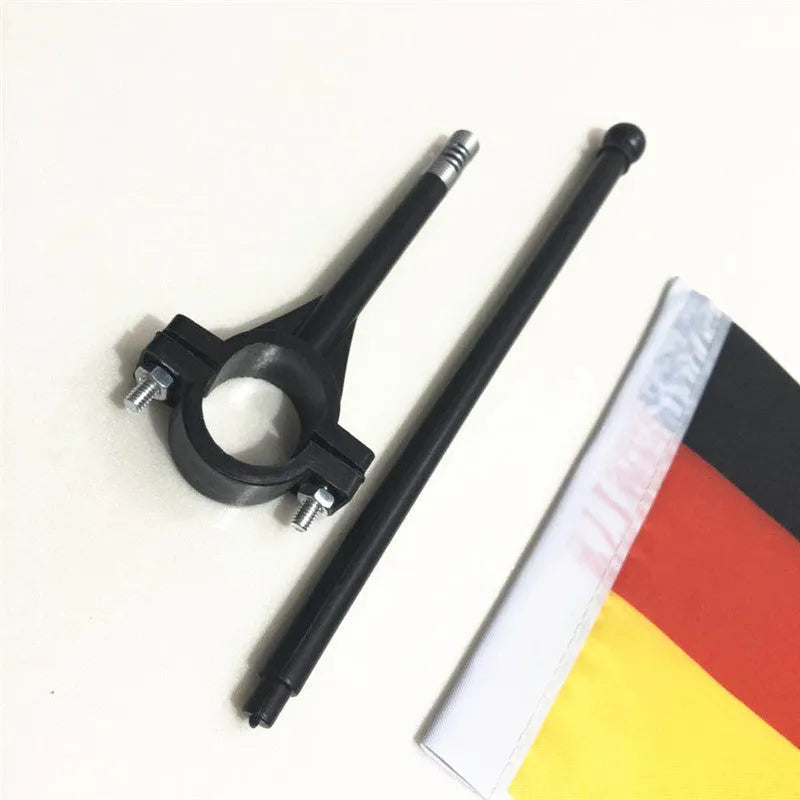 A square polyester cycling flag on a plastic pole, mounted on bicycle handlebars.