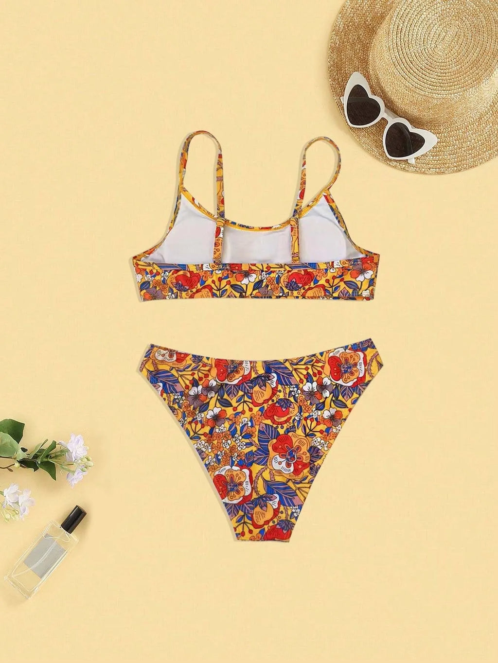 Plus size women's floral print strap bikini swimsuit two-piece set on a mannequin