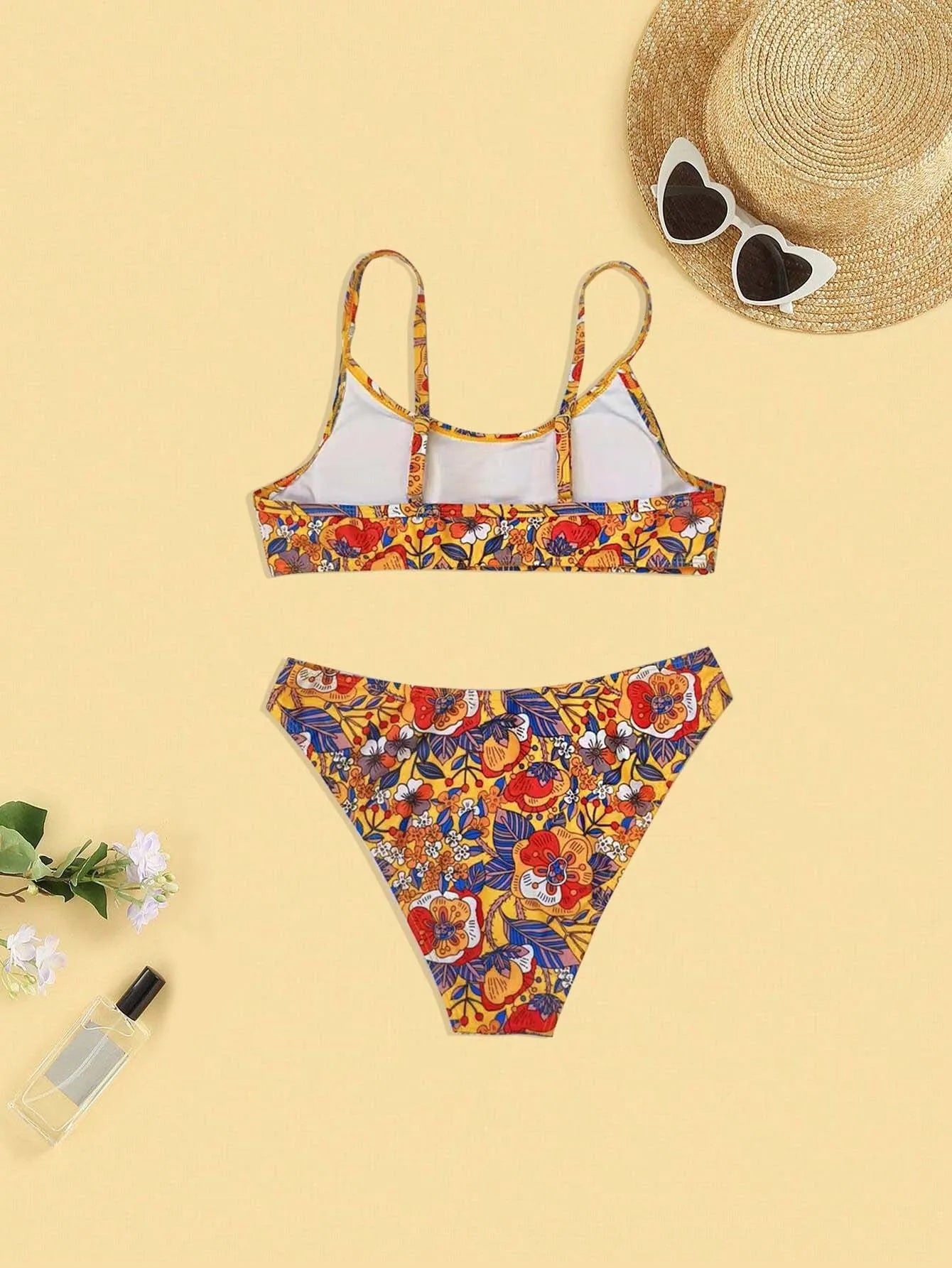 Plus size women's floral print strap bikini swimsuit two-piece set on a mannequin