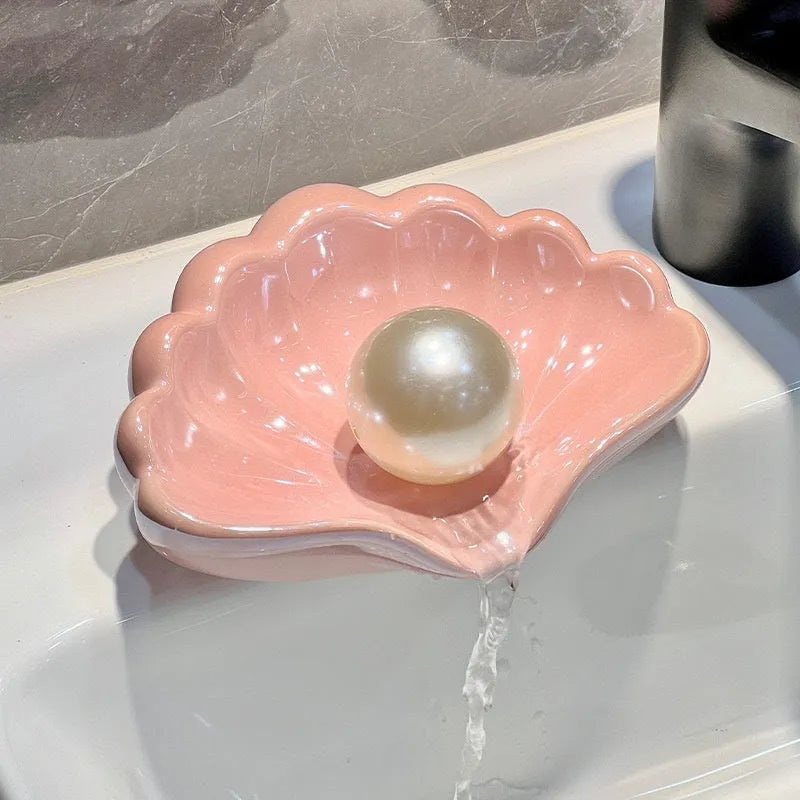 Plastic shell-shaped soap dish in pearl white colour for bathroom use