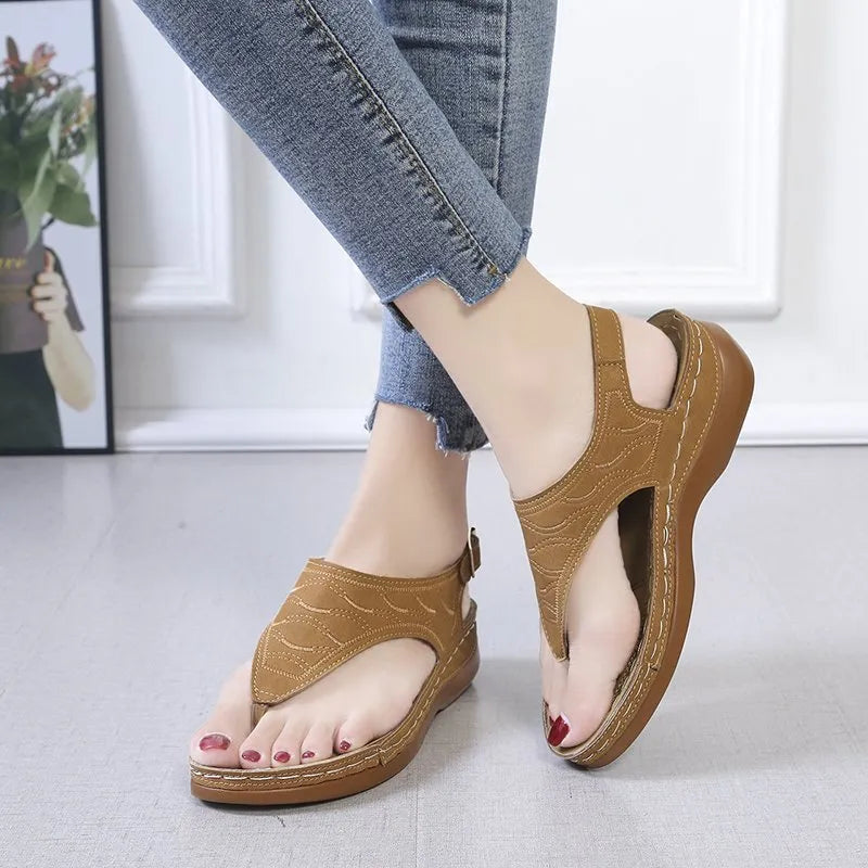 Women's wedge heel sandal in a solid colour with an adjustable back strap buckle.