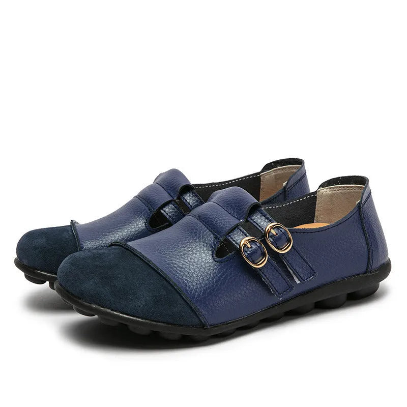 Casual low-top leather flat shoes with a round toe and a single Velcro strap closure.