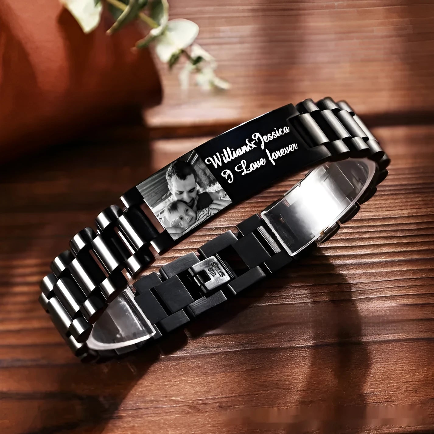 Titanium steel men's bracelet with curved heart shape design and black lettering on grey background