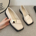 Women's beige artificial leather square toe flat-heeled slip-on ankle boots with a metal buckle.