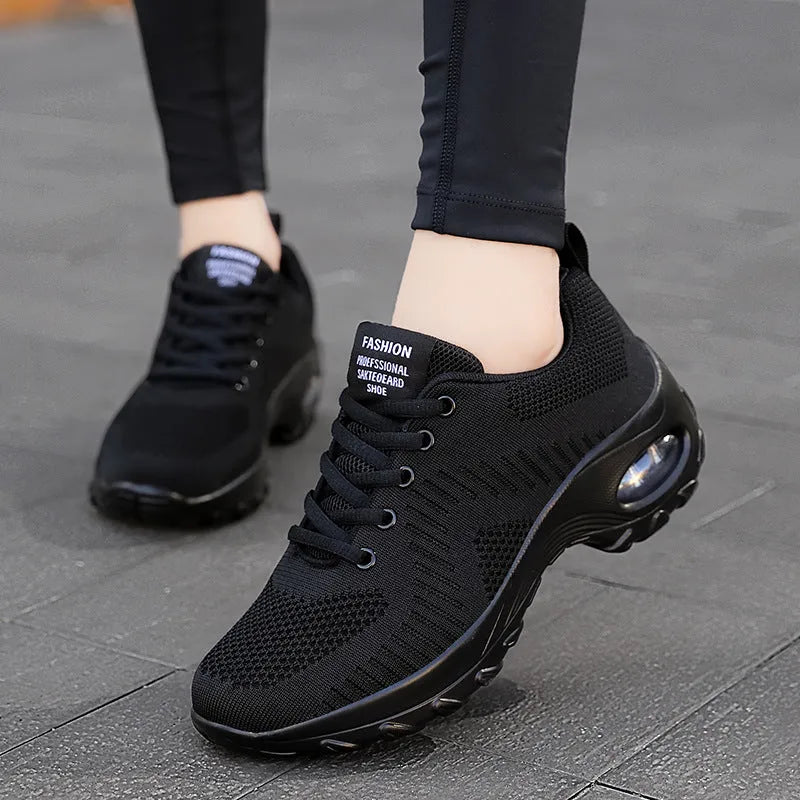 Women's black mesh sneakers with round toe and lace-up design, flat heel and low-top construction