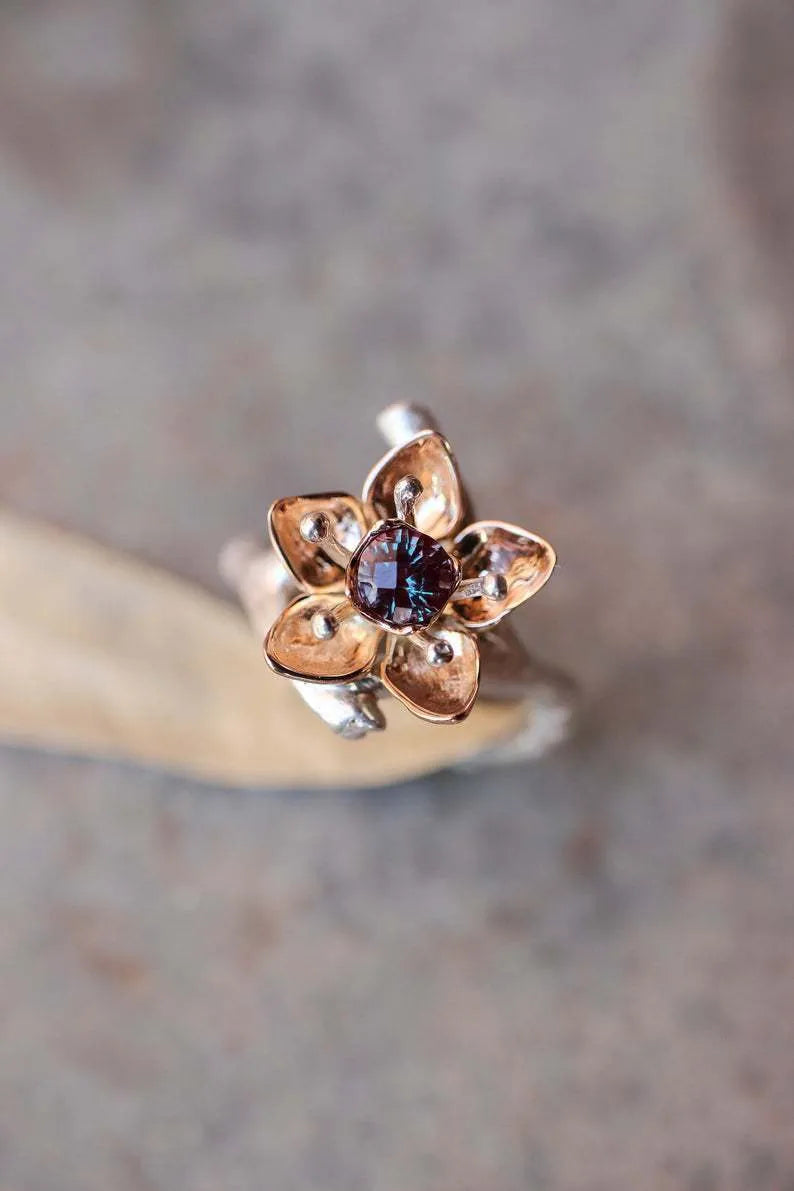 Silver two-tone floral geometric women's ring on display showing geometric shape and floral pattern detail.