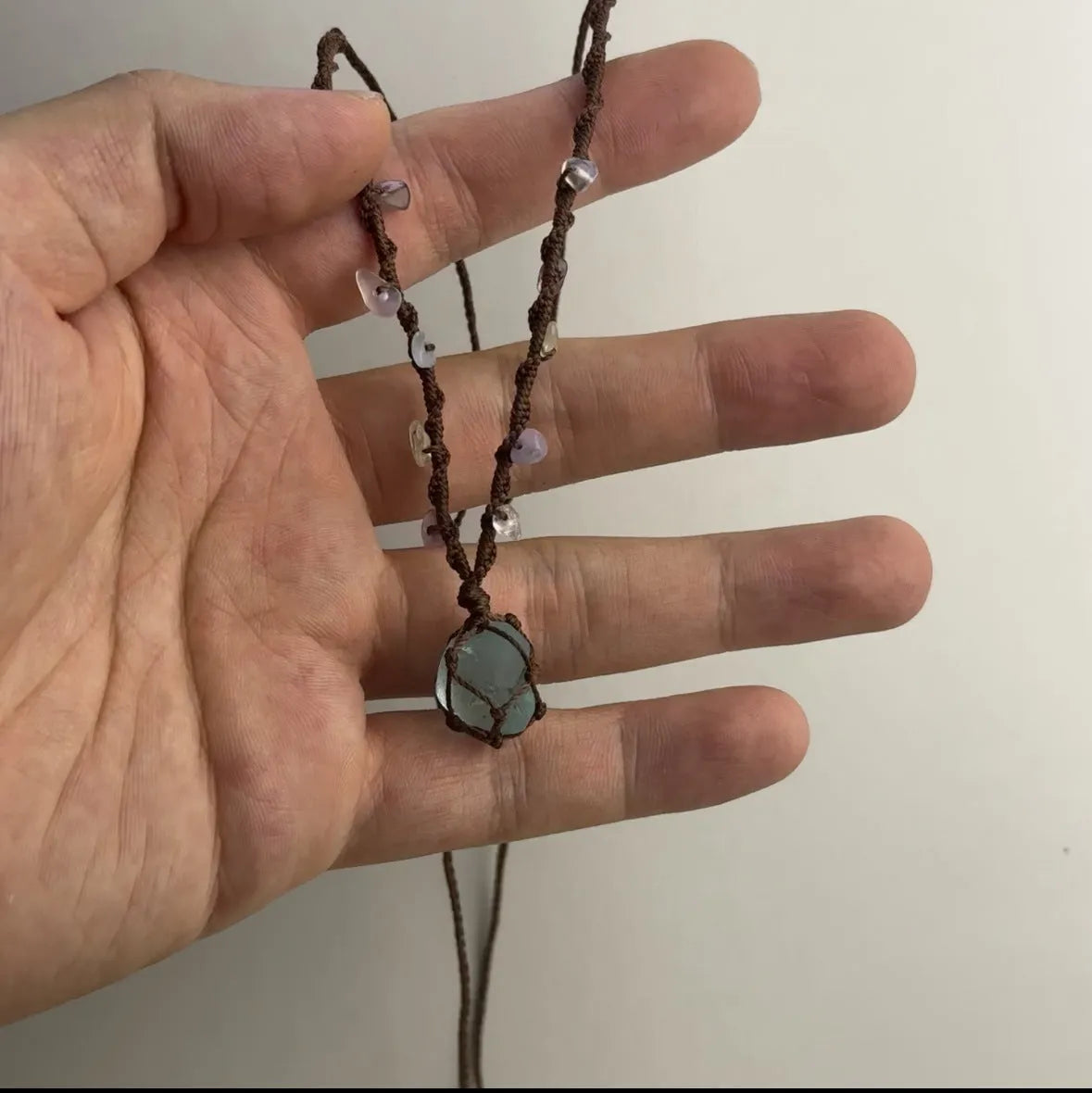 Artificial crystal rough labradorite-style pendant necklace with O-link chain on display