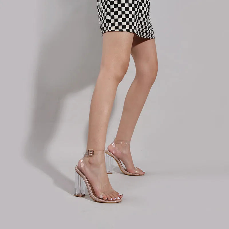 Apricot coloured women's high heel sandals with glass heel, buckle strap, and round toe.