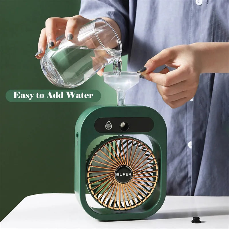 Green and white portable USB misting fan with water tank and adjustable air vent on a desk.