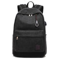 Canvas backpack with USB charging port showing computer compartment and multiple pockets