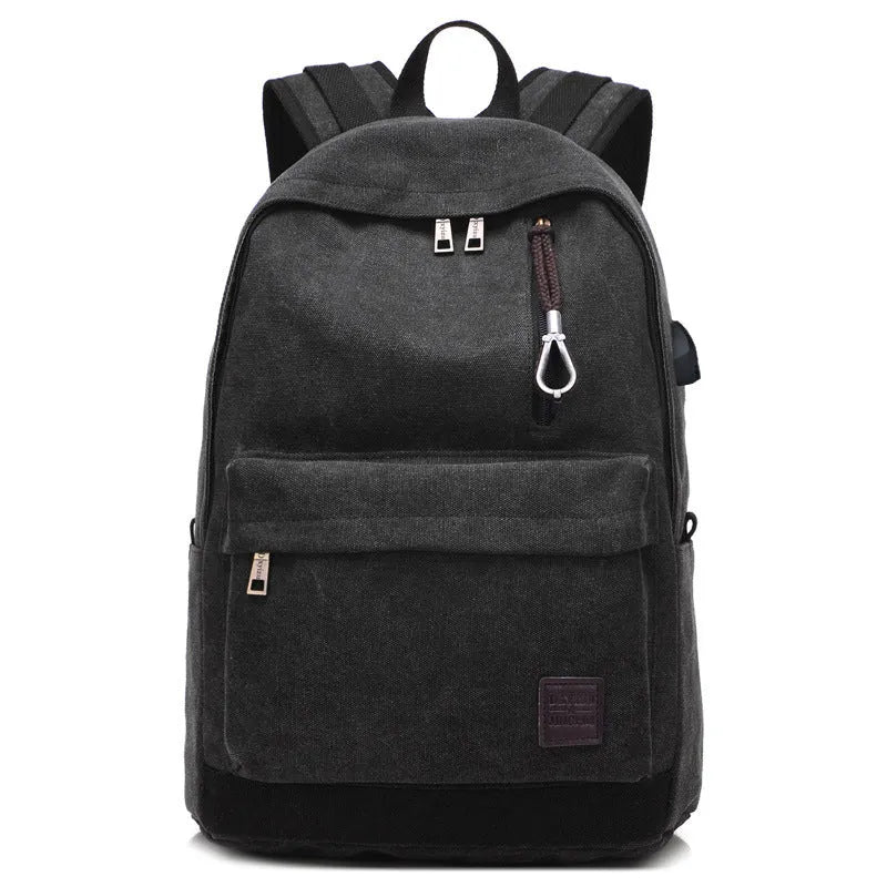 Canvas backpack with USB charging port showing computer compartment and multiple pockets