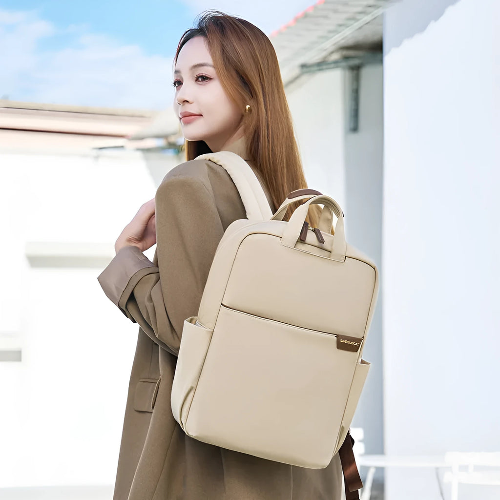 Canvas travel backpack for women in pink, black, or apricot with laptop sleeve and multiple internal pockets.
