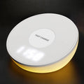 White wireless charging pad with digital clock display and control buttons for QI smartphone charging