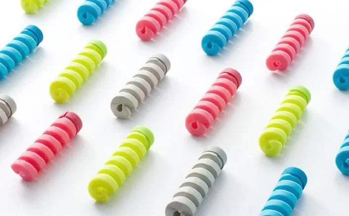 Two plastic cable protectors, 3.5cm long, in assorted colours next to a charging cable.