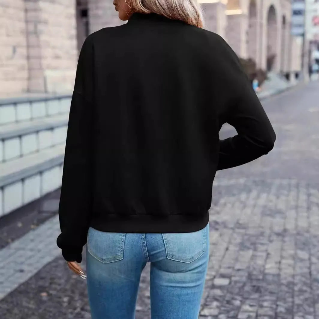 Black women's casual zip jacket with long sleeves on a hanger.
