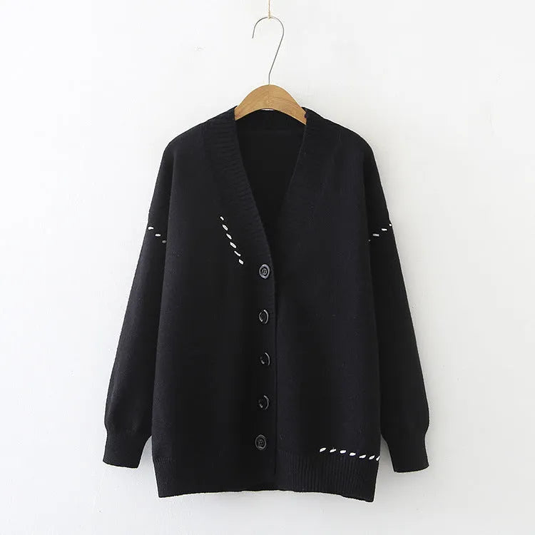 Women's loose fit knitted cardigan coat in black or white polyester with long sleeves