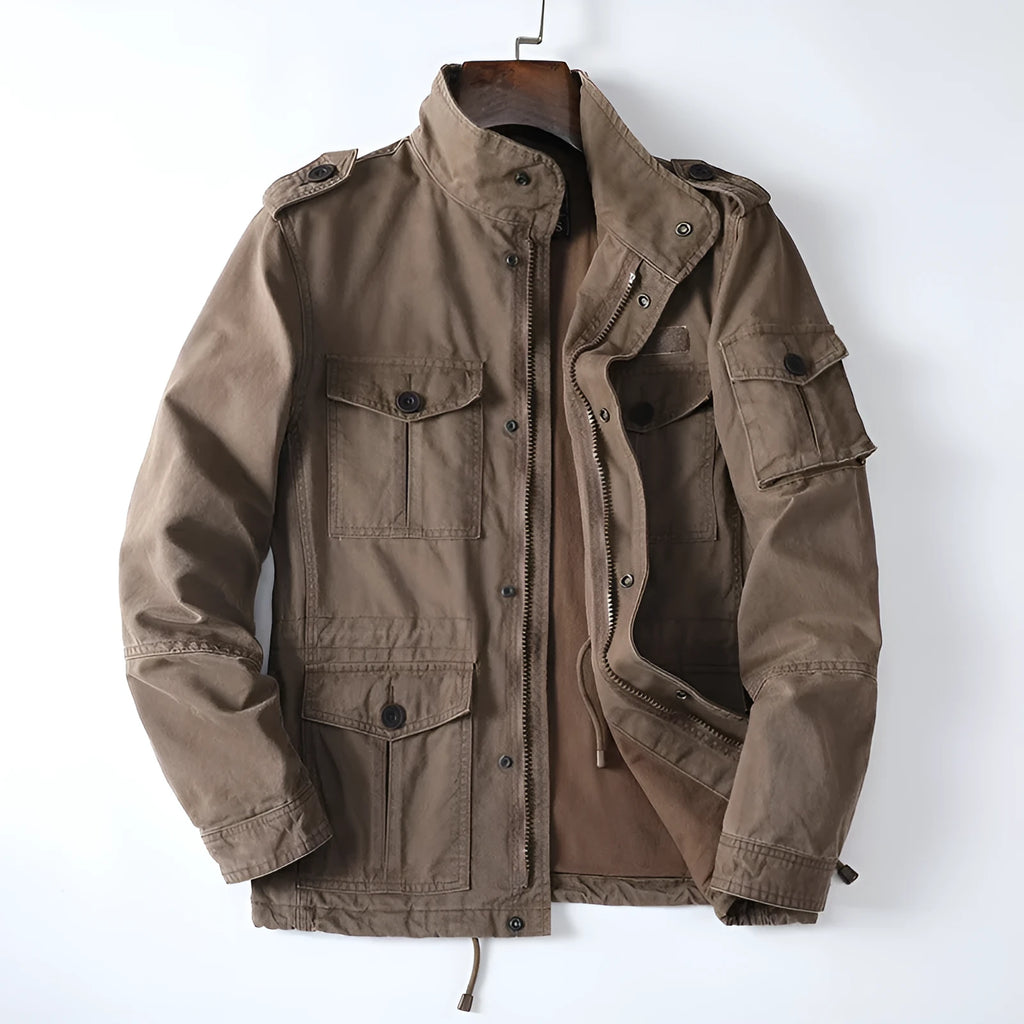 Man wearing a loose-fit light brown cotton twill zip-up jacket with a retro style.