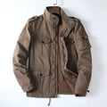 Man wearing a loose-fit light brown cotton twill zip-up jacket with a retro style.