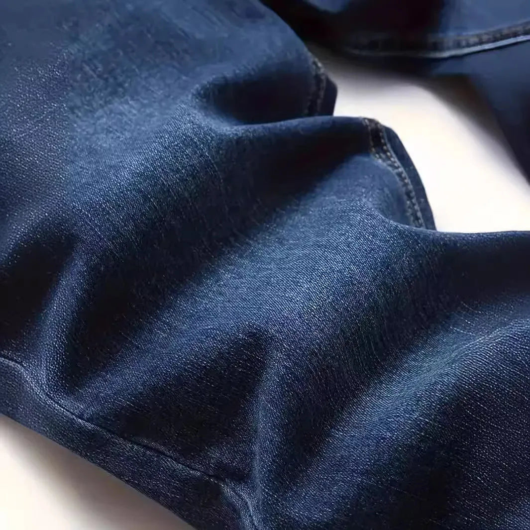 Men's dark blue slim fit cotton jeans showing skinny leg silhouette and street fashion style