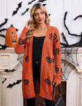 Women's black Halloween cardigan with orange Jacquard knitted pumpkin head pattern, shown on a hanger.