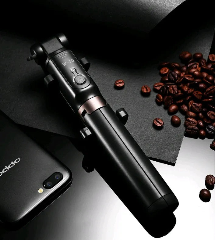 Black Bluetooth selfie stick with tripod bracket extended, holding smartphone
