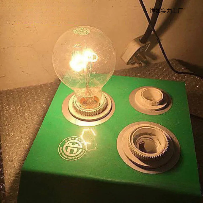 Tungsten incandescent household bulb with E27 screw base, clear glass, and visible filament
