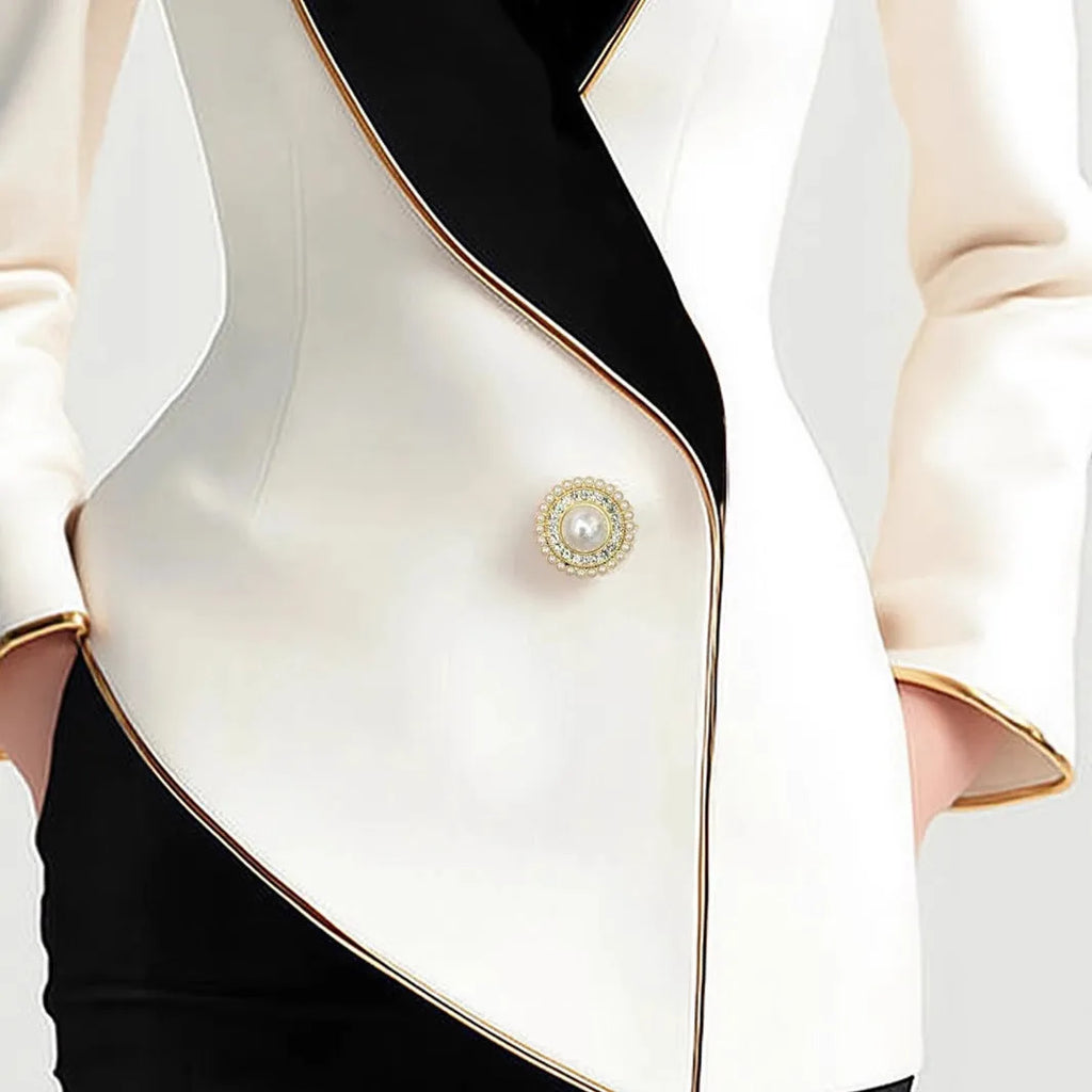 Women's milky white irregular cut long sleeve coat with golden pearl buttons on a hanger.