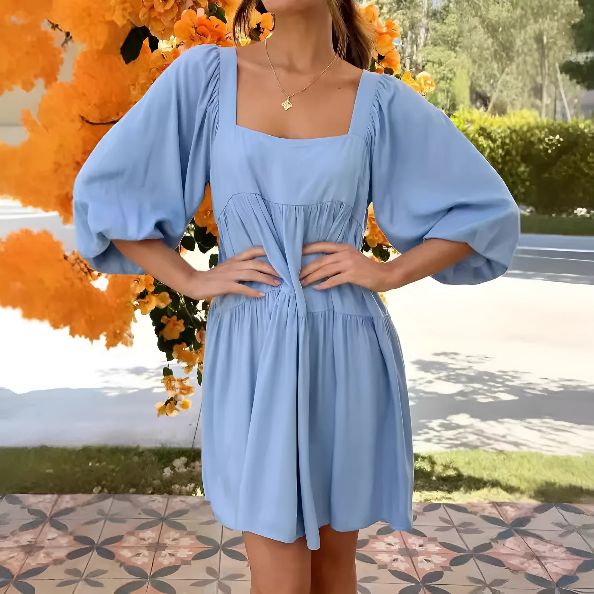 Orange backless children's dress with a square collar and puff sleeves in an A-line silhouette.