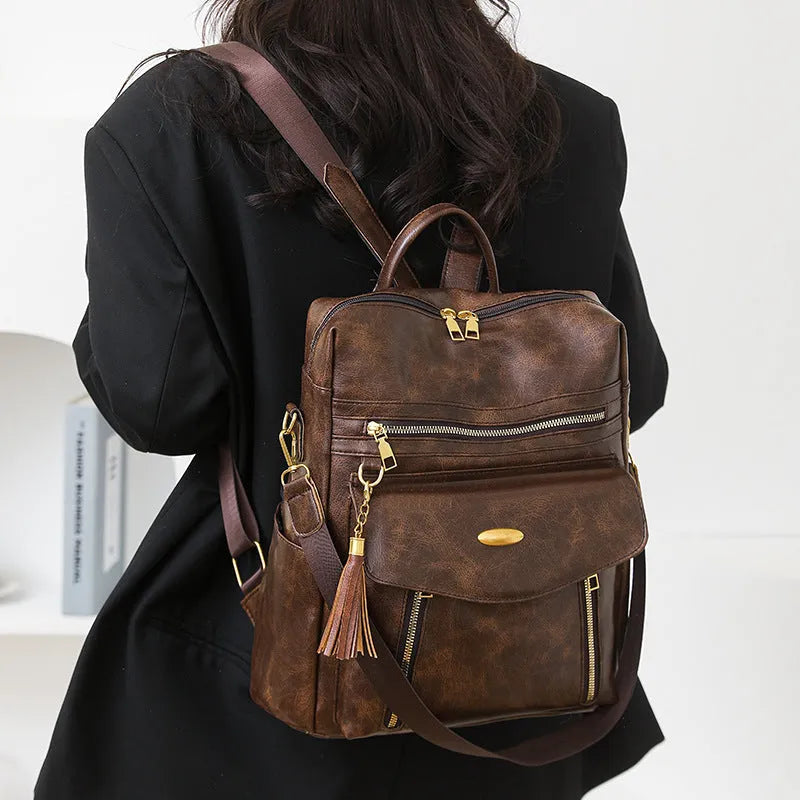 Crossbody casual ladies backpack in PU material with sewing thread detail, available in black, brown, and coffee