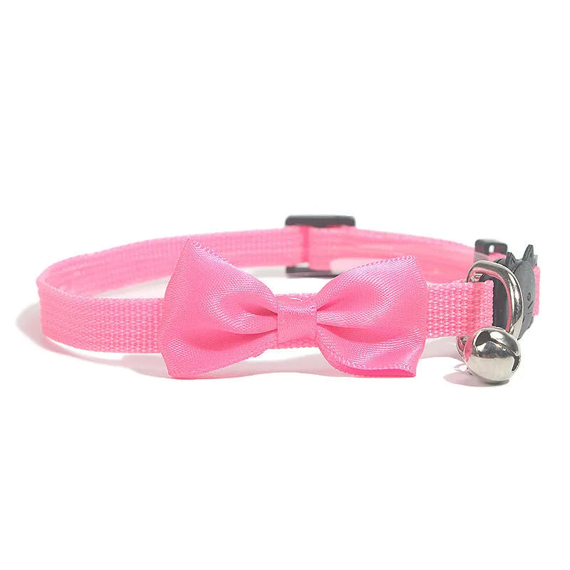 Adjustable nylon cat collar with decorative bow and bell in striped cartoon pattern, multiple colour options shown