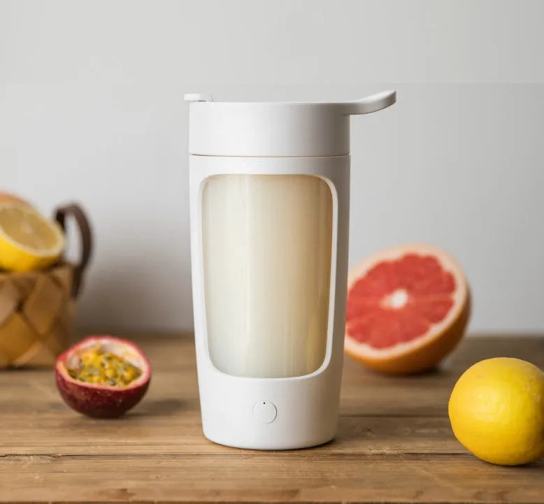 Portable USB-rechargeable blender cup in black, blue, pink or white, showing 650ml capacity markings.