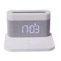 White or black four-in-one bedside lamp with wireless phone charging pad, digital clock display, and LED lighting
