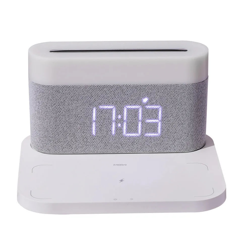 White or black four-in-one bedside lamp with wireless phone charging pad, digital clock display, and LED lighting