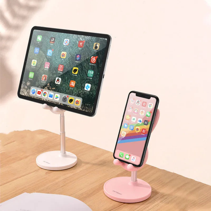 Silicone rabbit phone stand in pink on a desk holding a smartphone at an adjustable angle