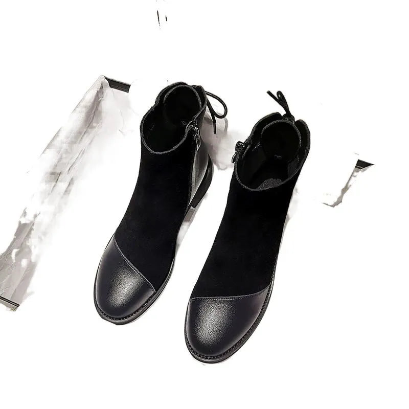 Black women's knee-high Martin boots with side zip, round toe, decorative bow, and rubber sole.