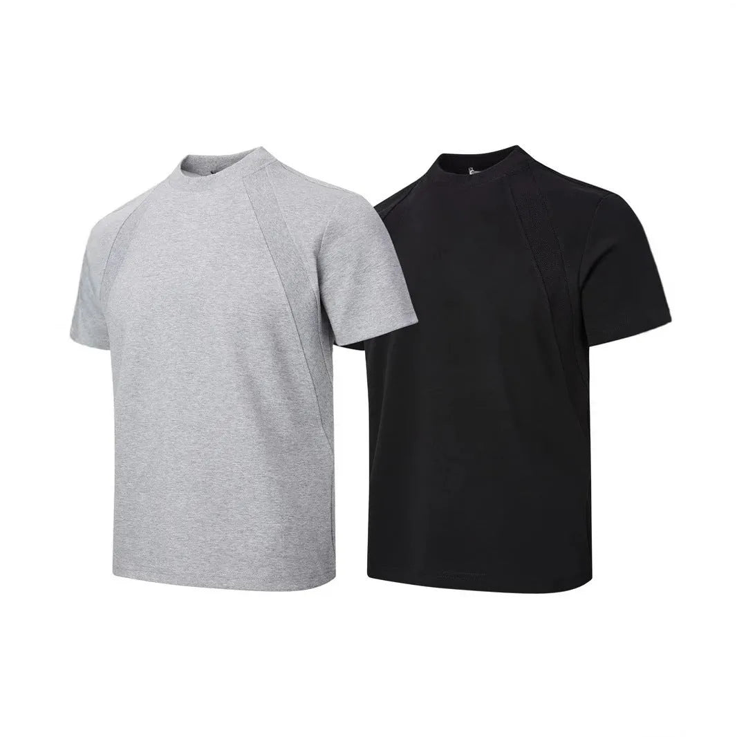 Men's loose black short sleeve top with textured air layer stitching on a grey background