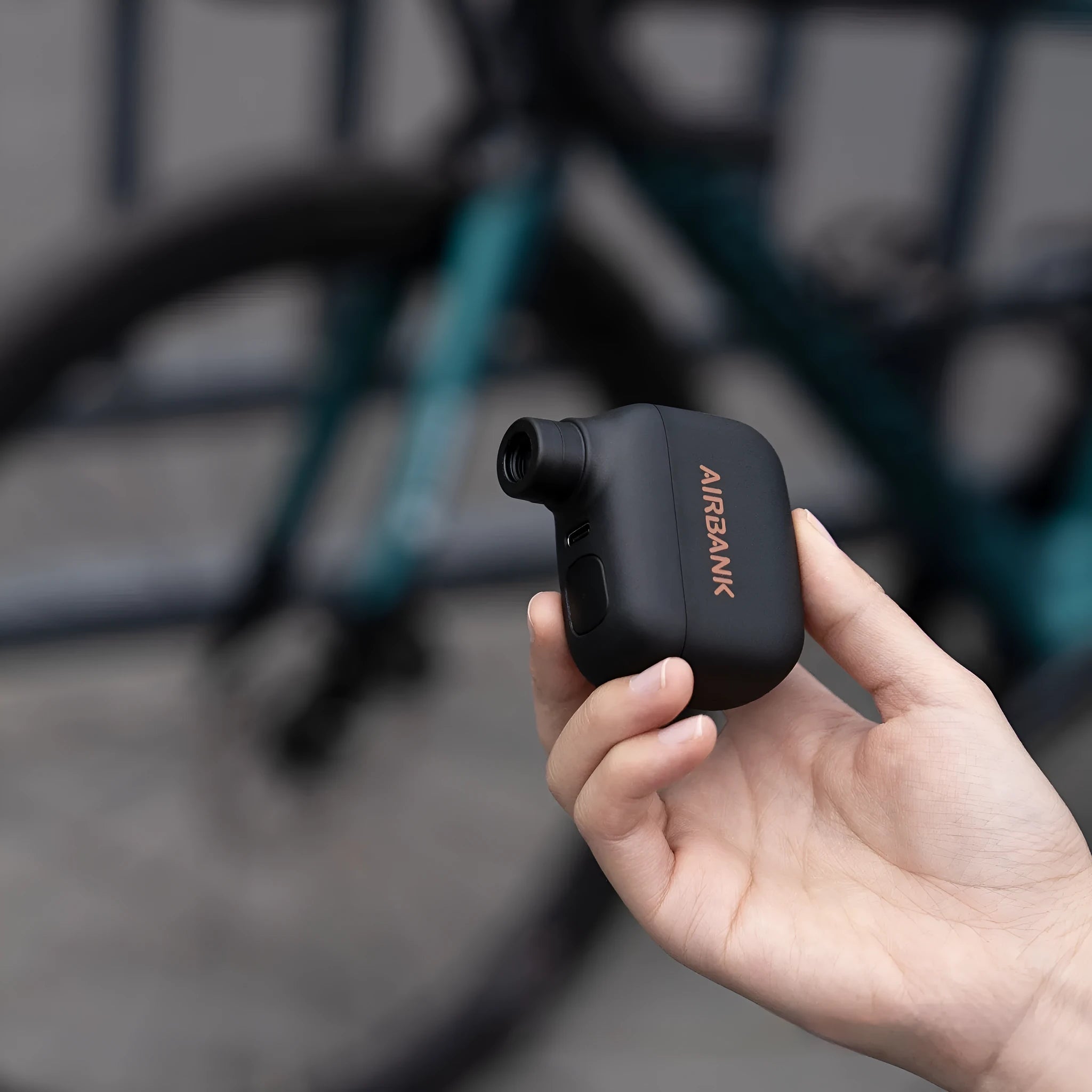 Black AS100 mini electric bicycle pump with USB cable and waterproof storage bag