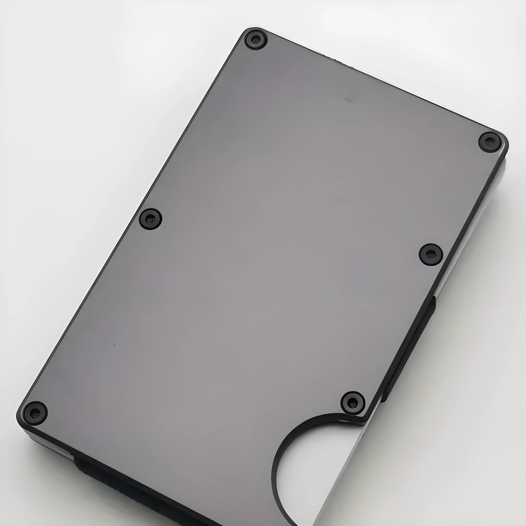 Grey carbon fibre wallet with aluminium alloy frame showing RFID blocking anti-theft technology