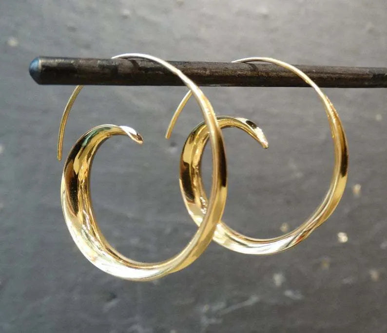 Gold alloy geometric round spiral leaf ear studs with electroplated finish on white background