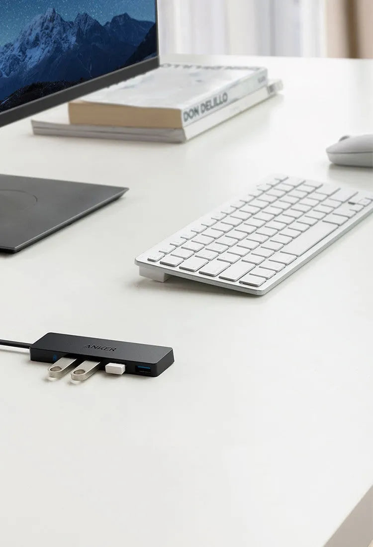 Black Anker 4-port USB 3.0 hub with attached cable on a desk