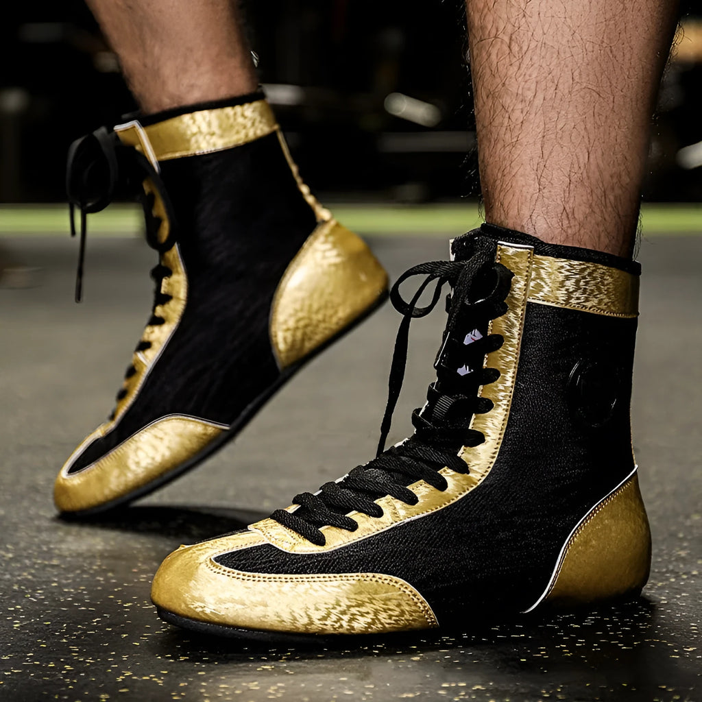 Professional black and gold mesh boxing shoe for indoor wrestling and training.